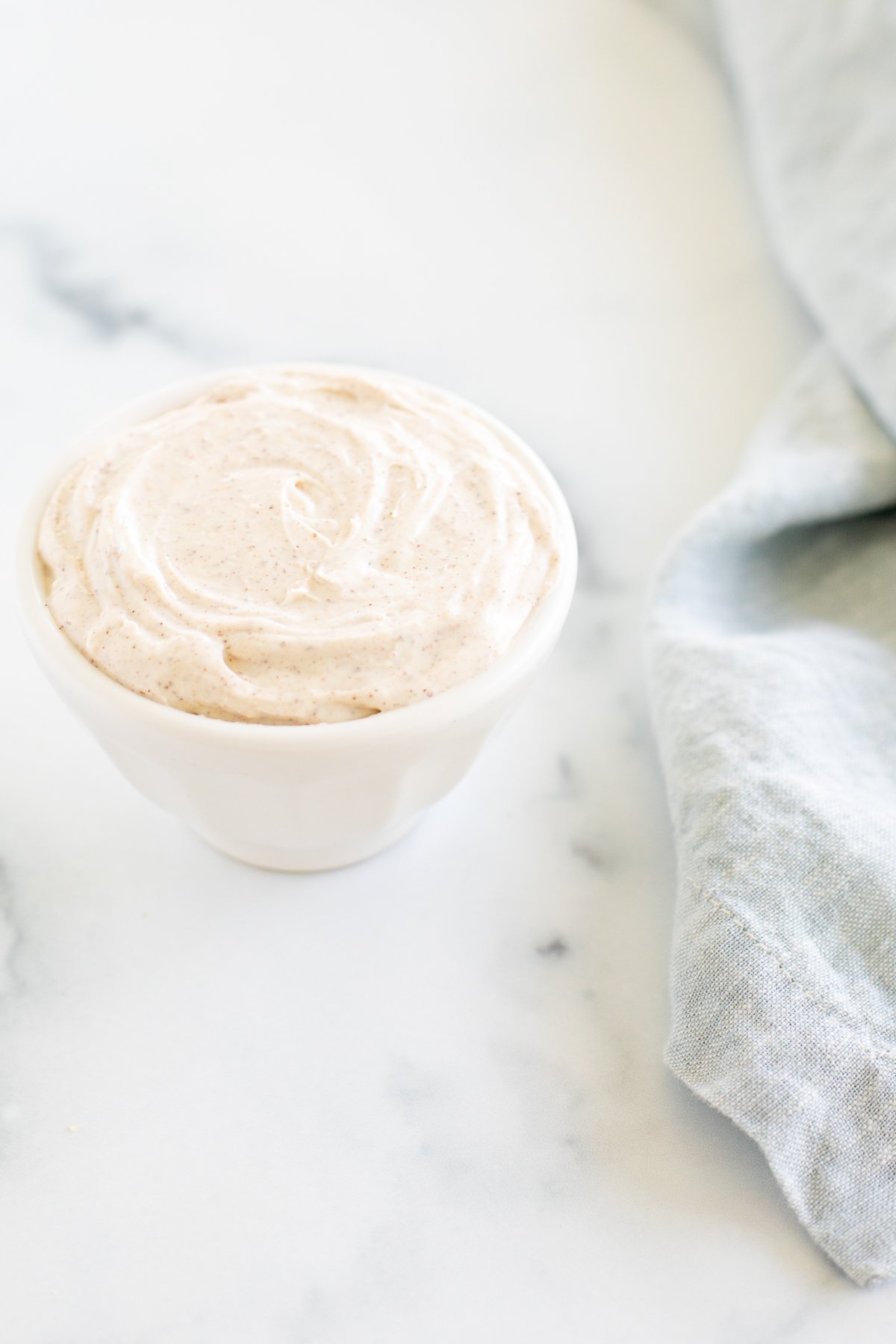 A white bowl of cinnamon cream cheese.