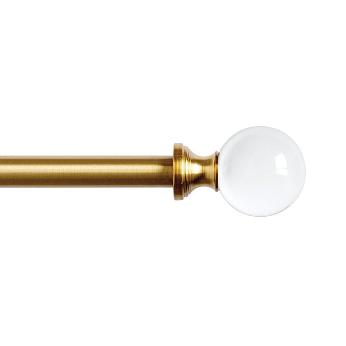 A brass curtain rod with a glass ball on it perfectly complements pinch pleat drapes.