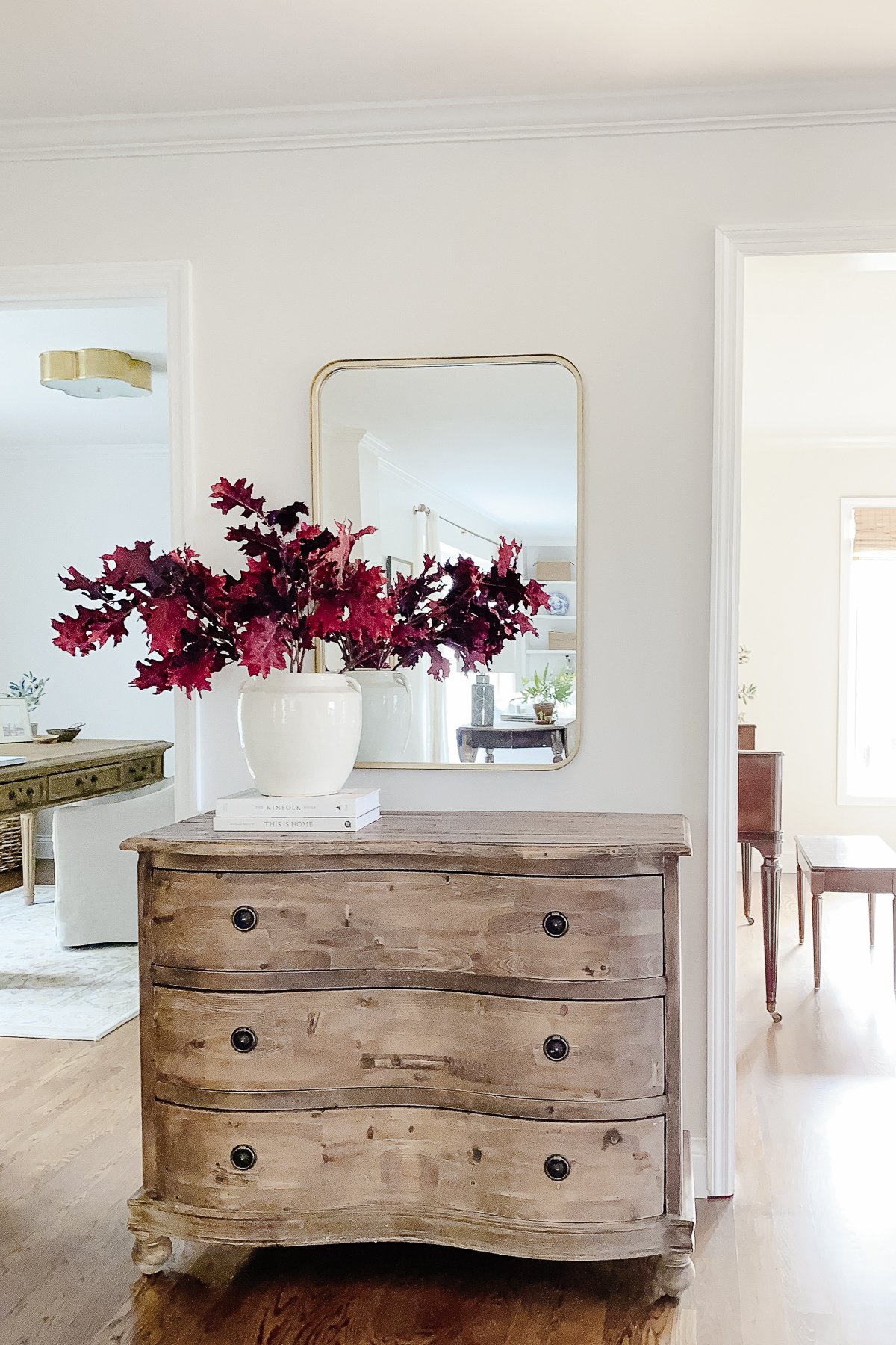 A dresser with fall branches.