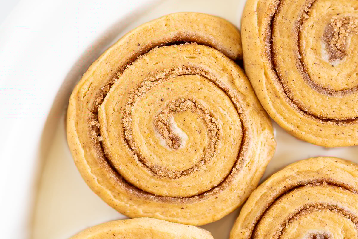 A plate of Pumpkin Cinnamon Rolls on a white plate.