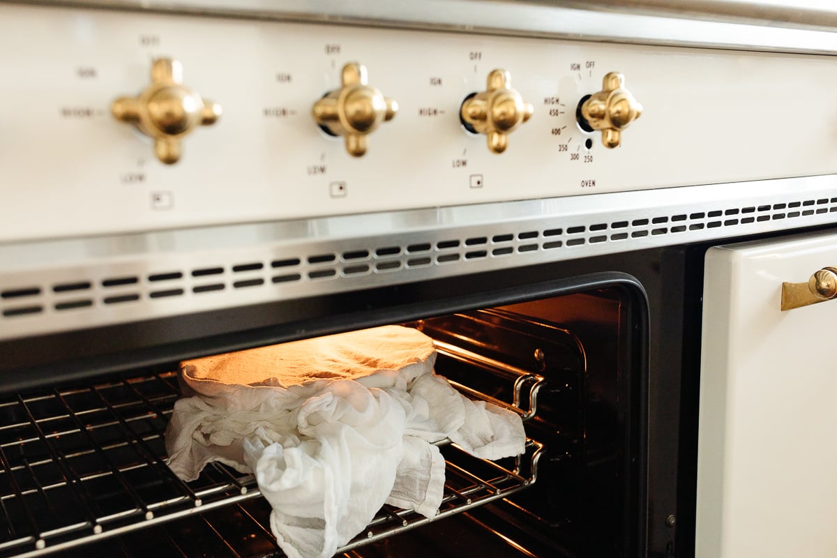 A white oven with a bag of Pumpkin Cinnamon Rolls in it.