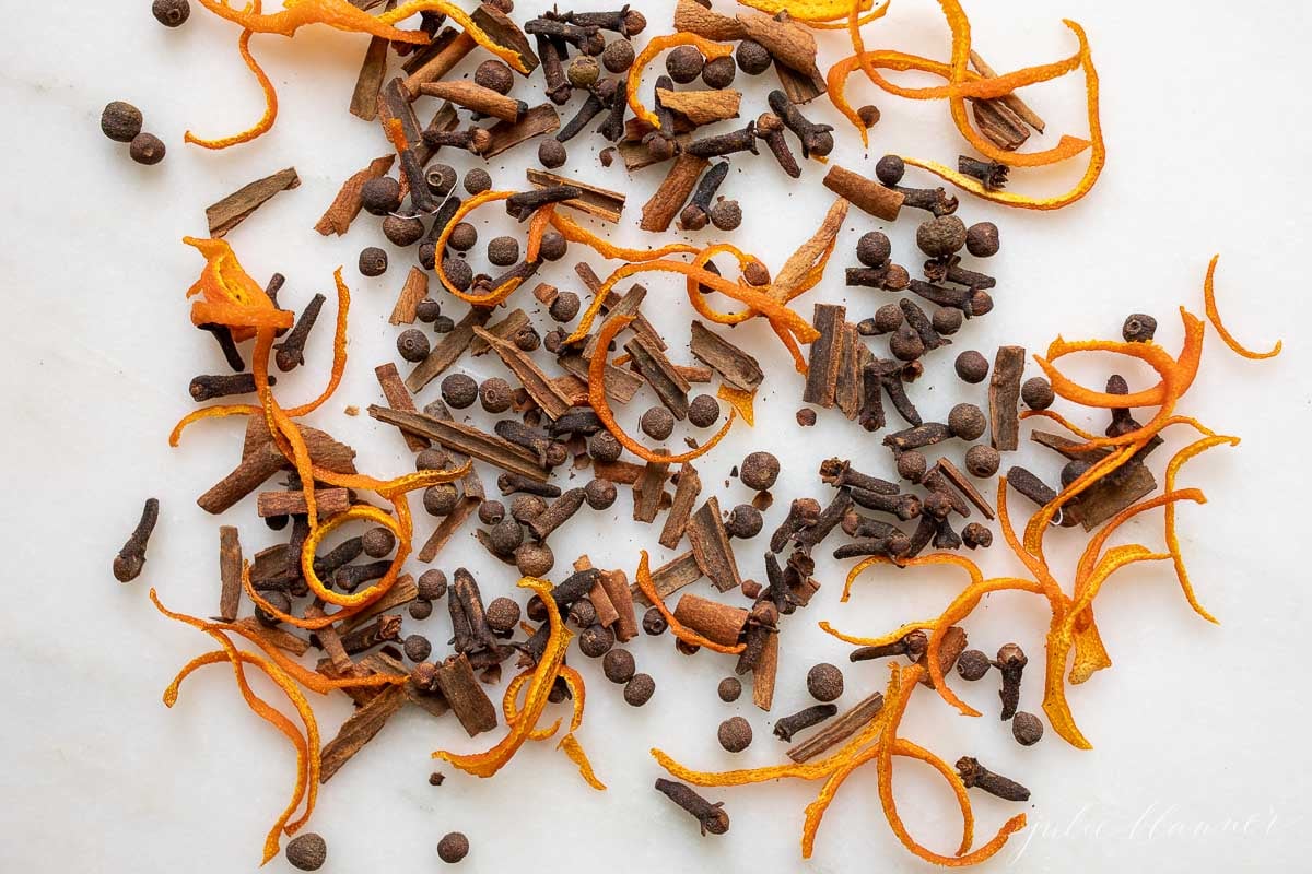 A pile of mulling spices on a white surface.
