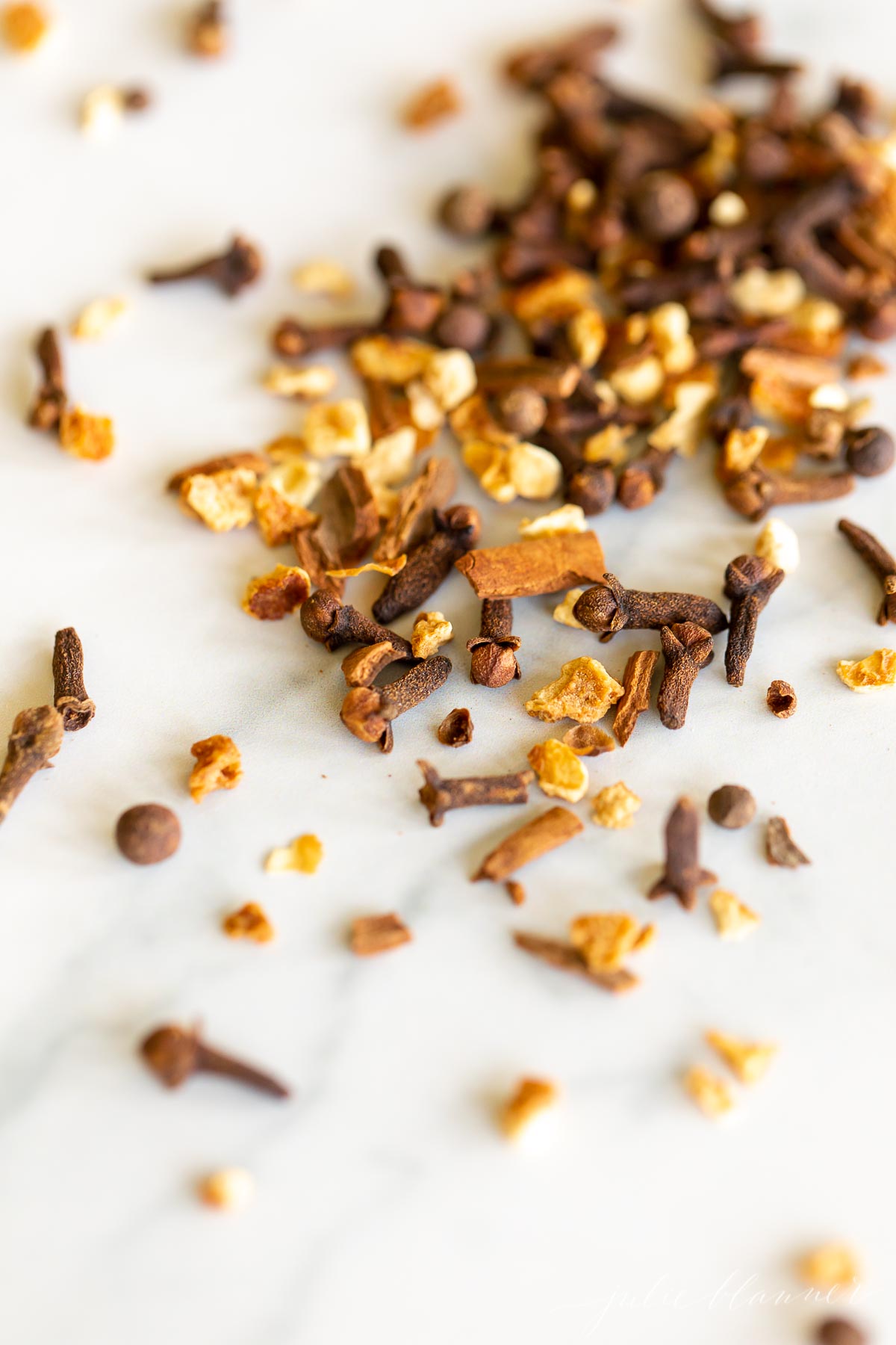 A pile of mulling spices on a white surface.