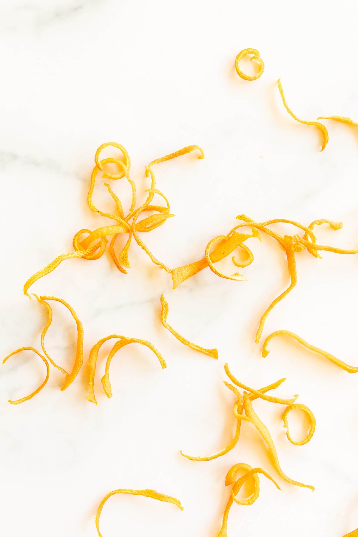 A pile of orange peels on a marble surface