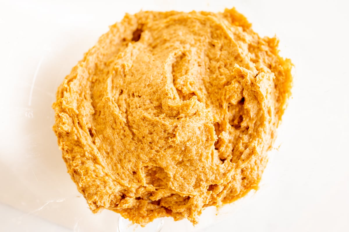 A close up of a pumpkin shaped dough, ready to be transformed into delicious Pumpkin Cinnamon Rolls.