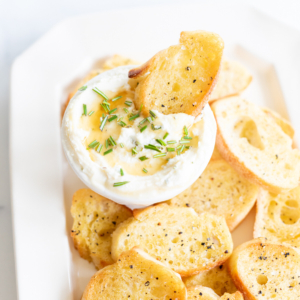 A plate with easy Thanksgiving appetizers, including bread and dip on it.