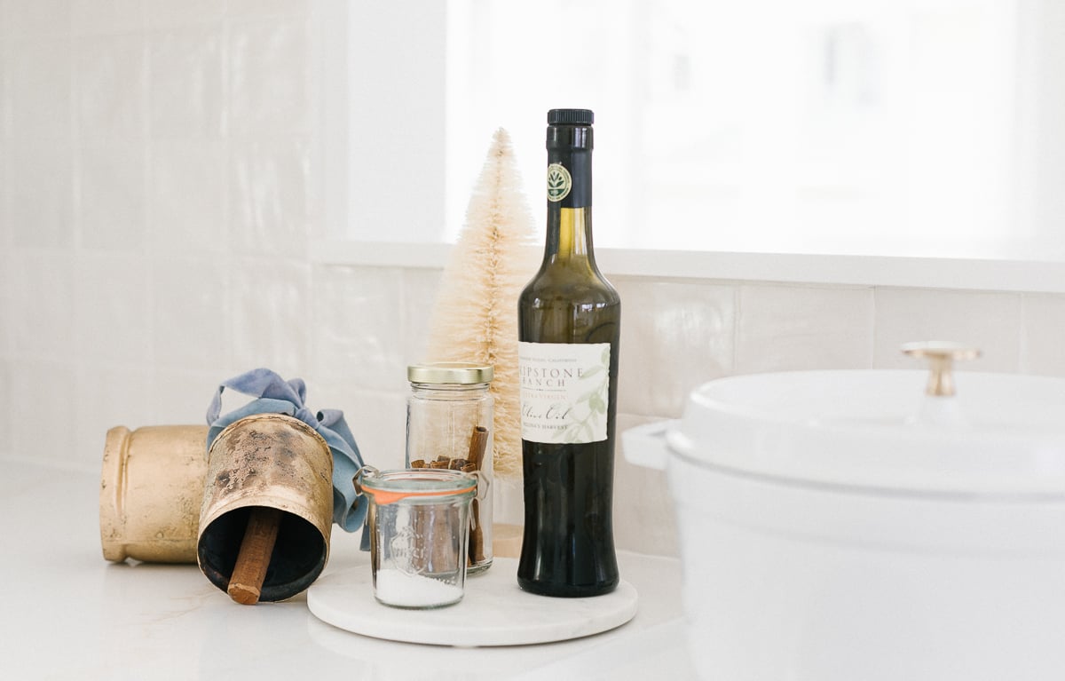 A bottle of wine sits on a counter next to a sink.