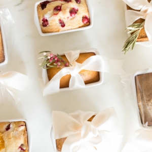 A variety of breads with bows and ribbons on a table.