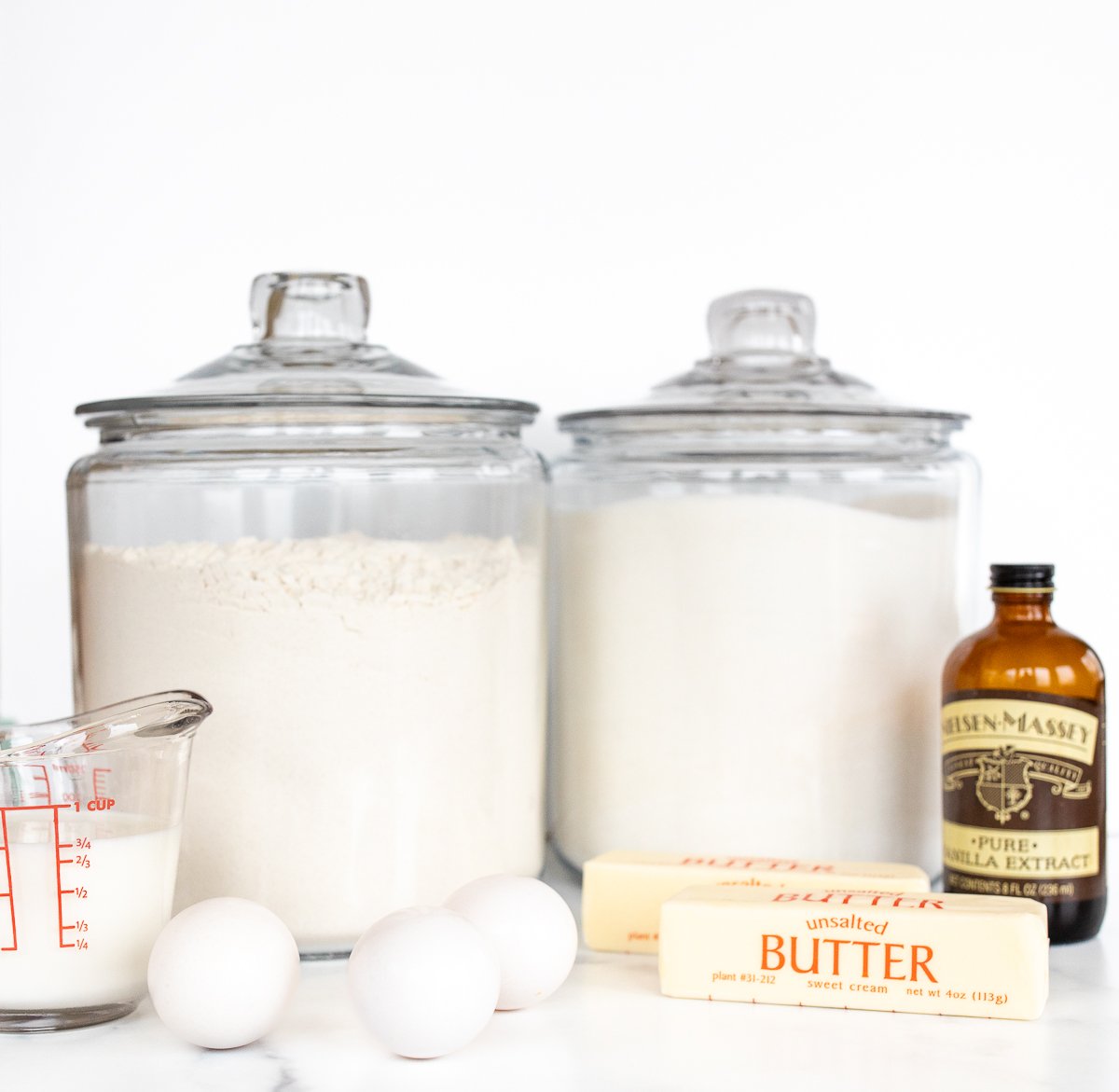 Jars of flour and sugar on a counter for Christmas Bundt Cake.