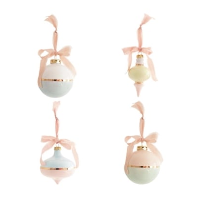 Three pink and white christmas decorations with bows on them.