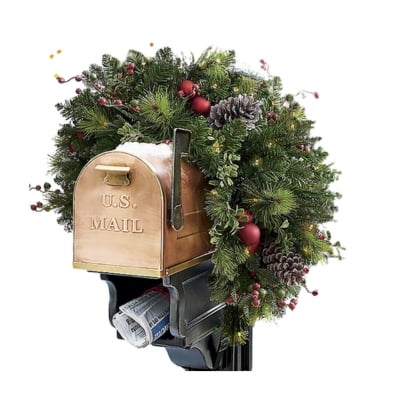 A festive Christmas mailbox decorated with a wreath and pine cones.