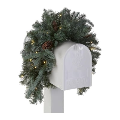 A festive mailbox adorned with a beautiful Christmas garland featuring delicate pine cones.