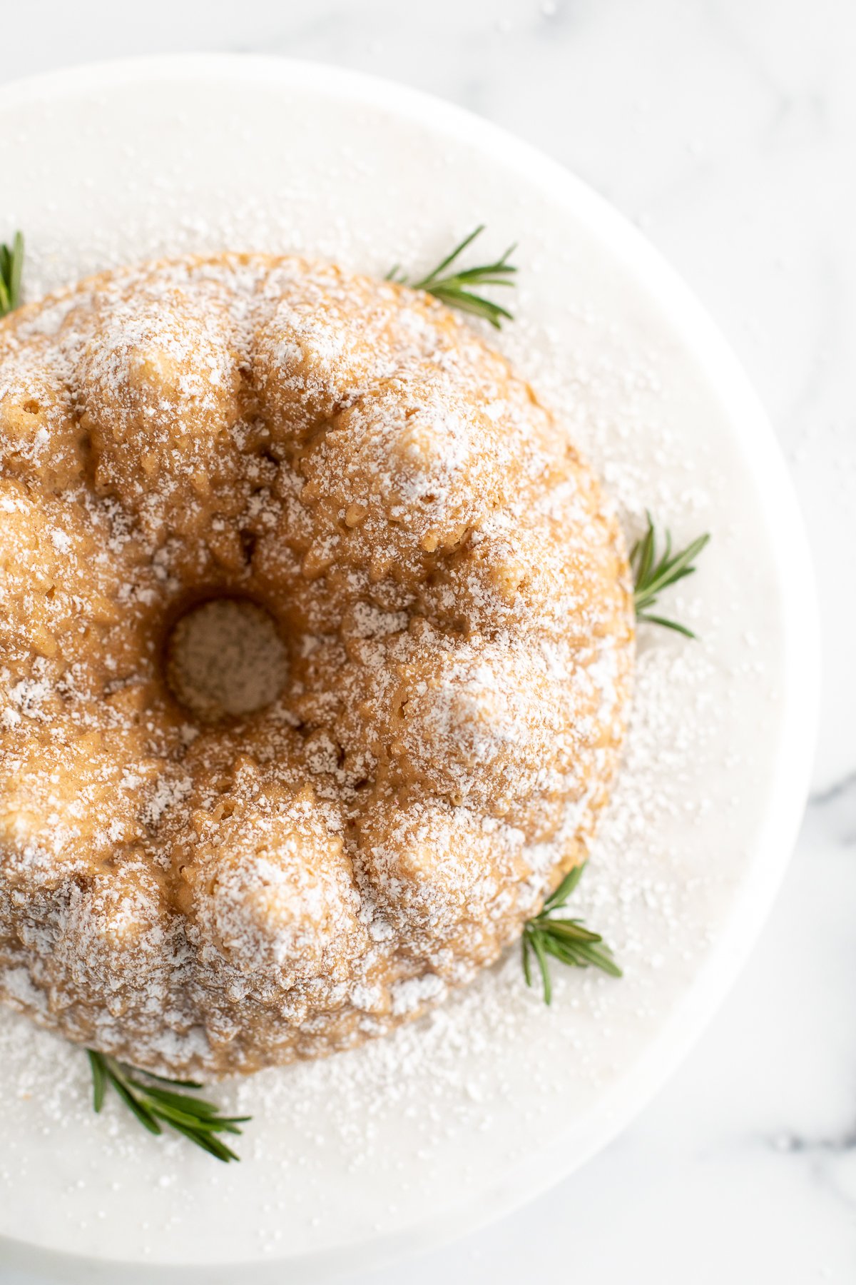 A Christmas Bundt Cake with rosemary and powdered sugar.