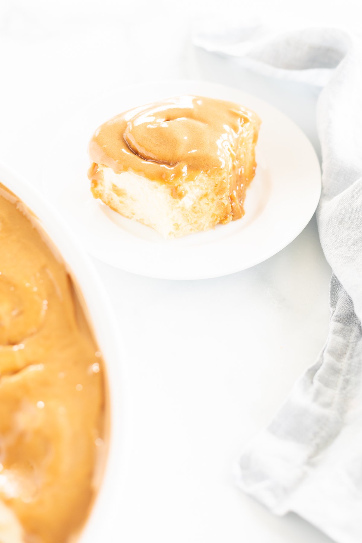 A plate with a piece of cookie butter cinnamon rolls and a napkin next to it, showcasing delicious Cookie Butter Cinnamon Rolls.