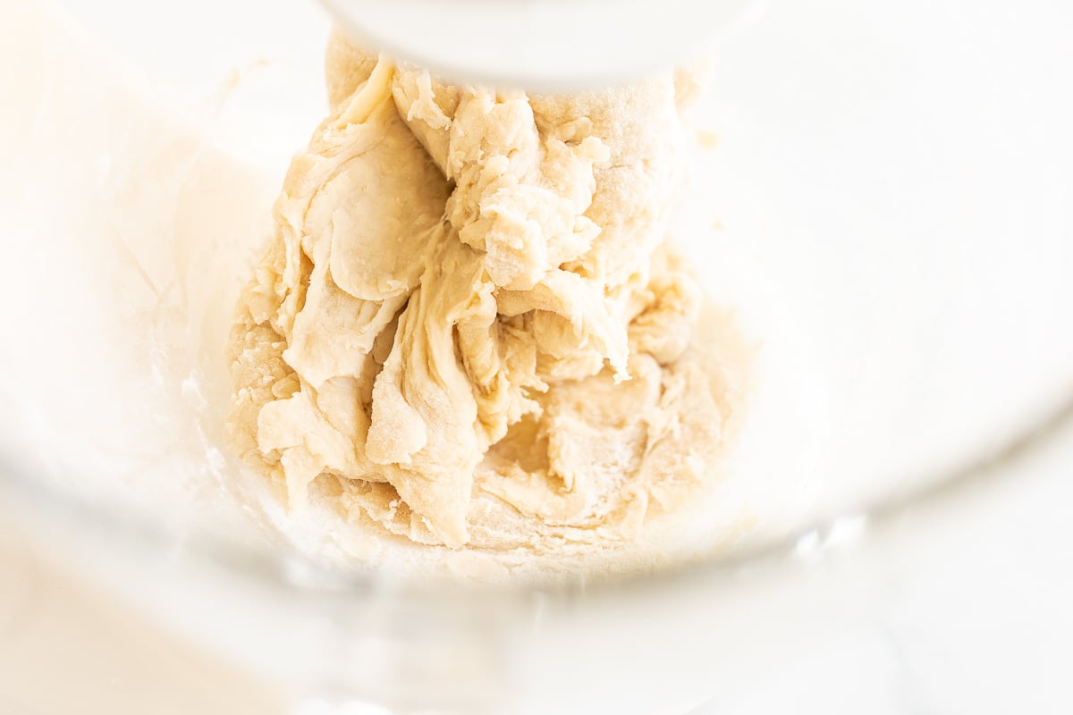 Cookie dough being mixed in a food processor.