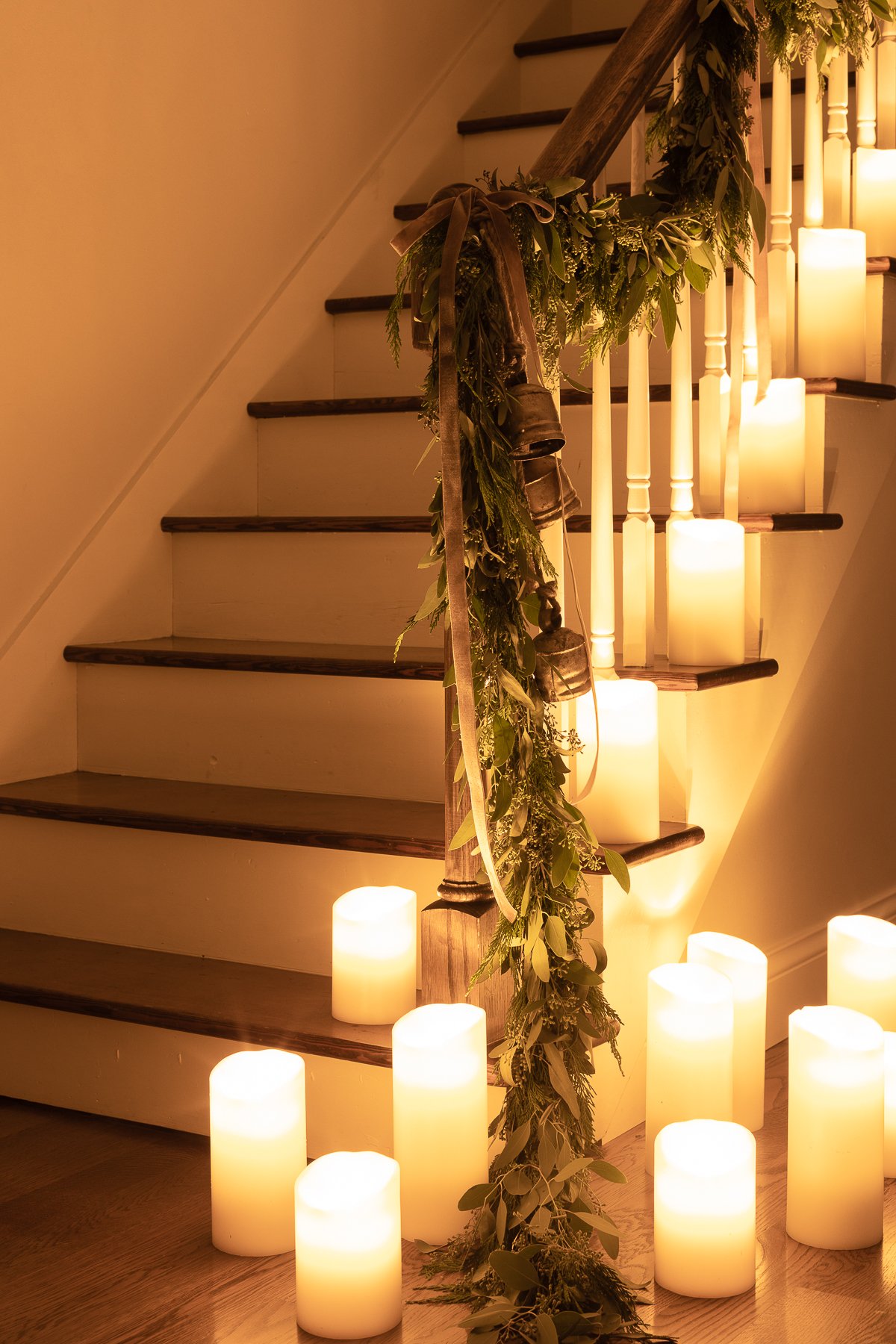 A staircase with flameless candles and garlands on it.