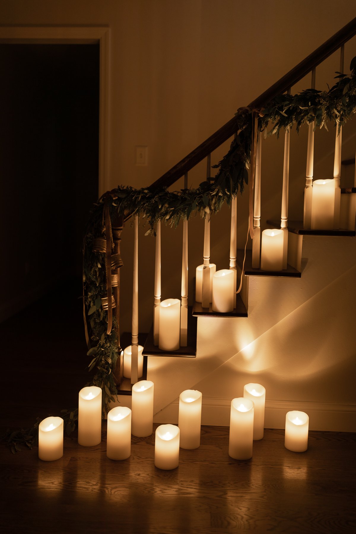 A group of LED candles on the stairs in a house.