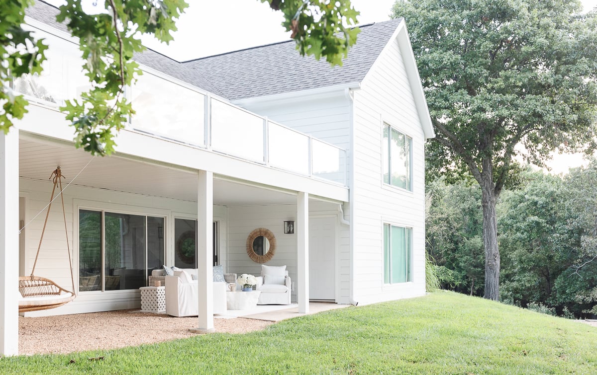 A James Hardie arctic white house with a rattan swing. 