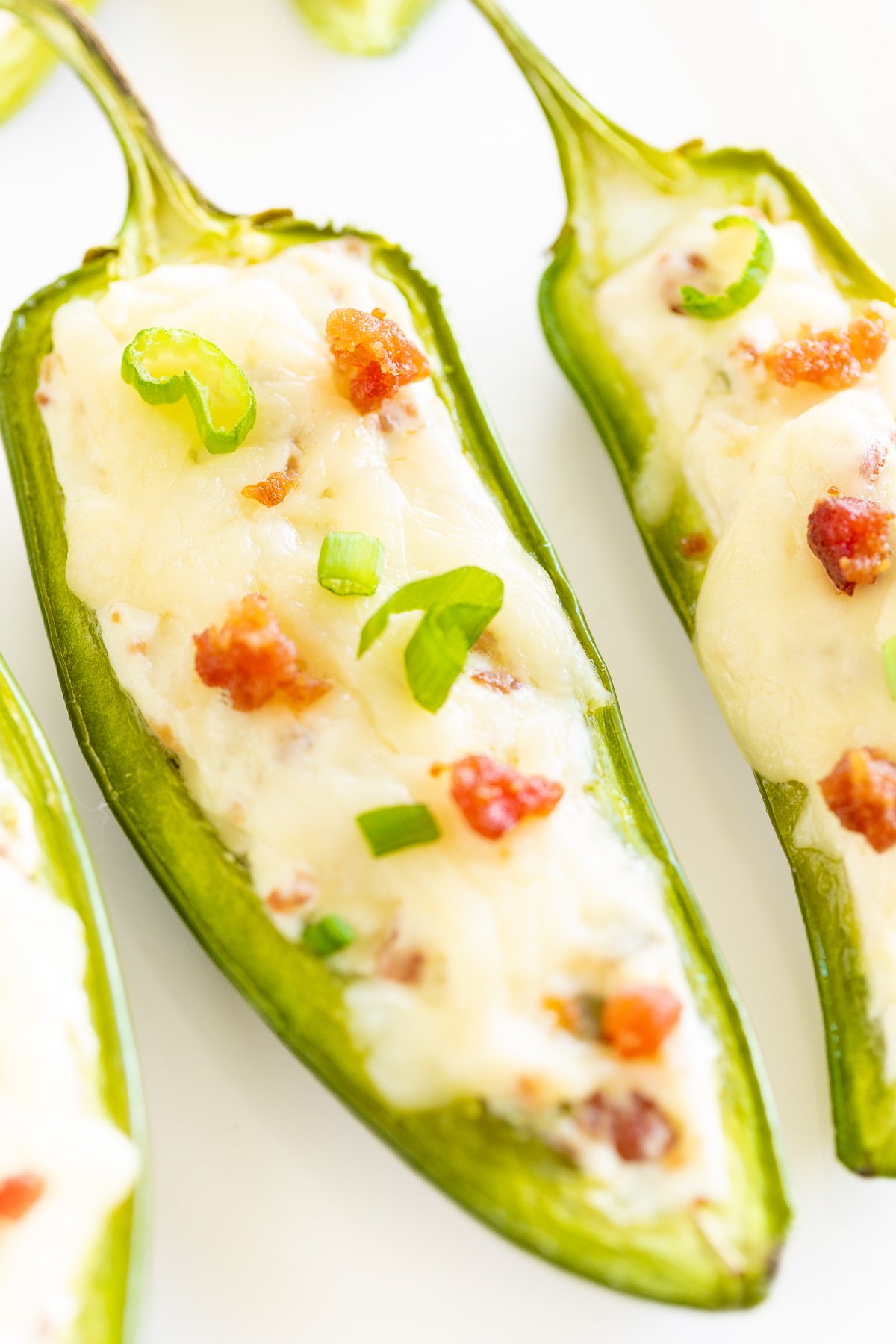 Stuffed jalapenos on a white plate.
