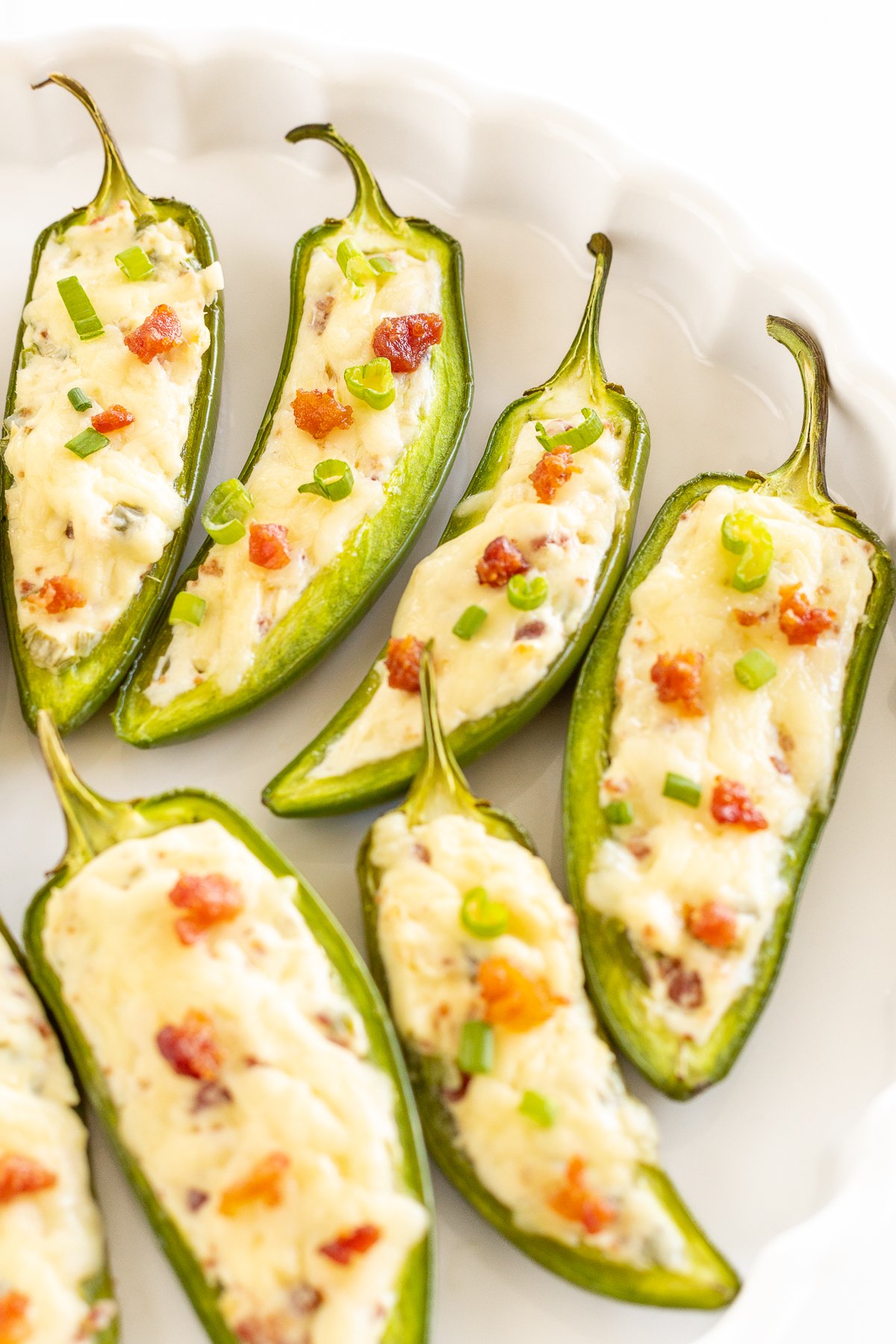 Stuffed jalapenos on a white plate.