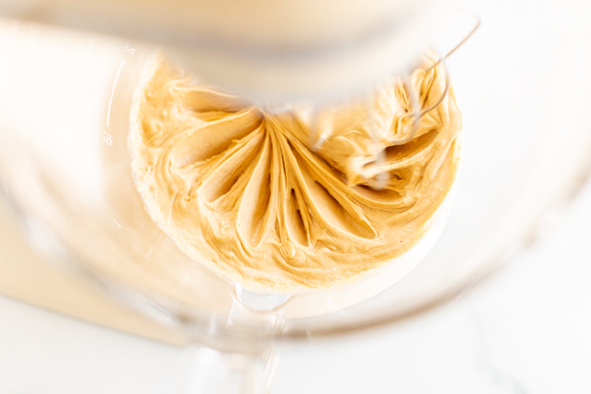 Cookie butter frosting in a bowl of a stand mixer.