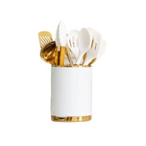 White and gold kitchen utensils in a matching holder, including spatulas and tongs, offer both style and efficiency for seamless kitchen counter organization.