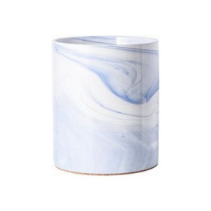 A cylindrical white ceramic vase with blue marbled patterns elegantly complements your kitchen counter organization, adding both style and functionality.