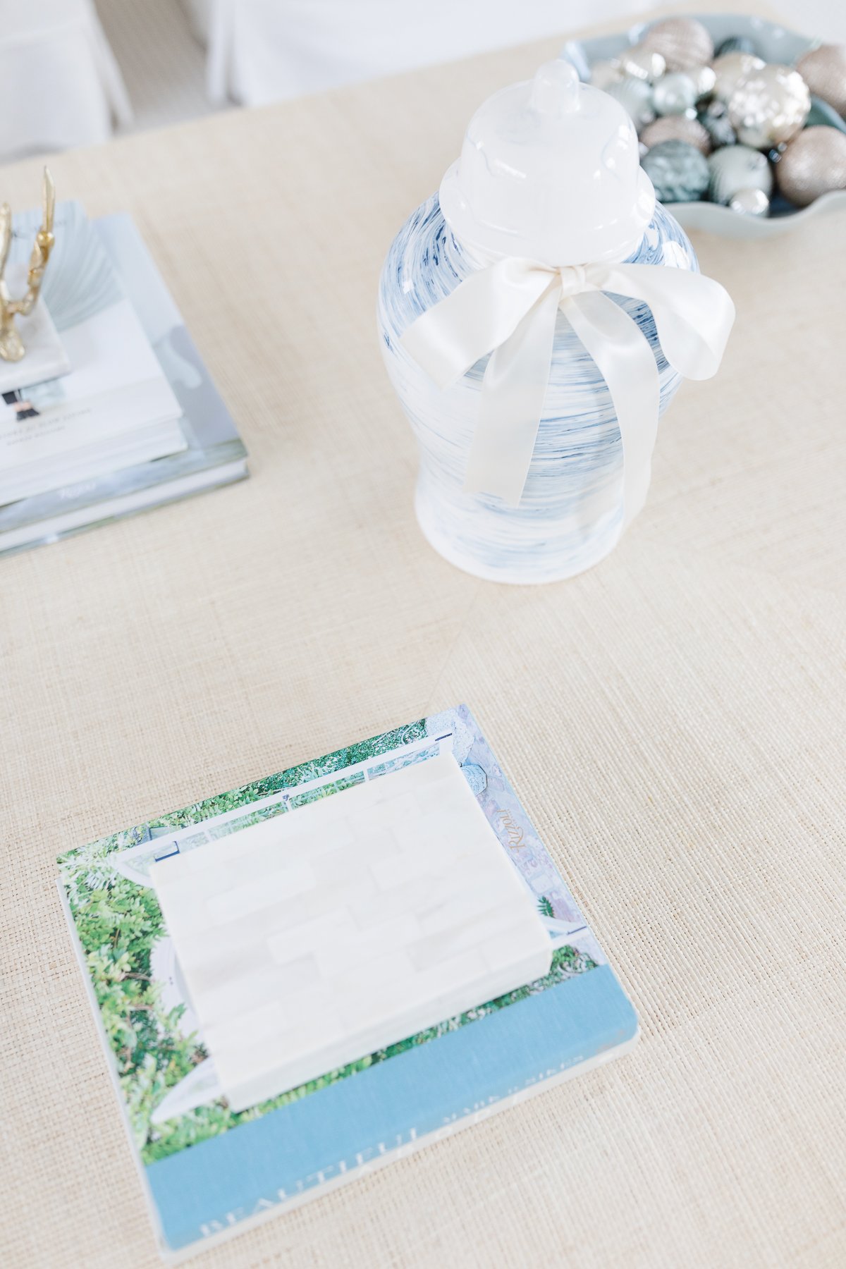 A white vase on a table.