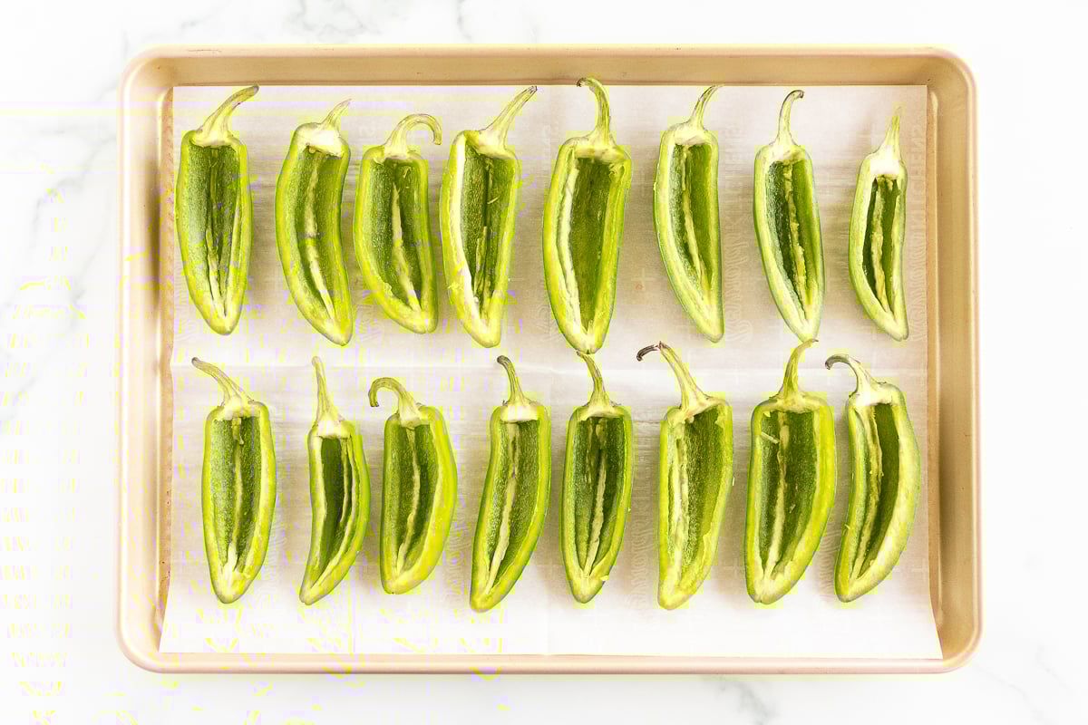 Green peppers on a baking sheet.