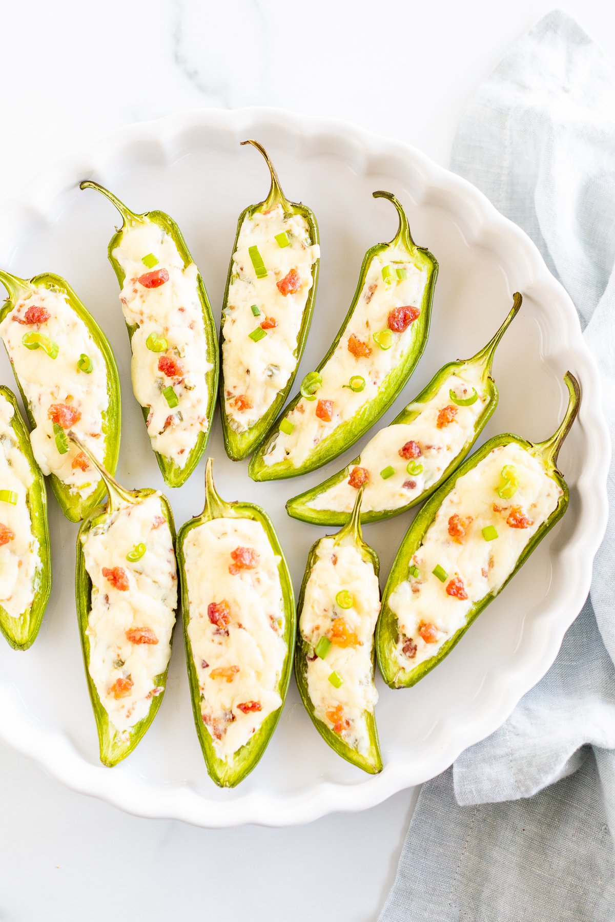 Stuffed jalapenos on a white plate.