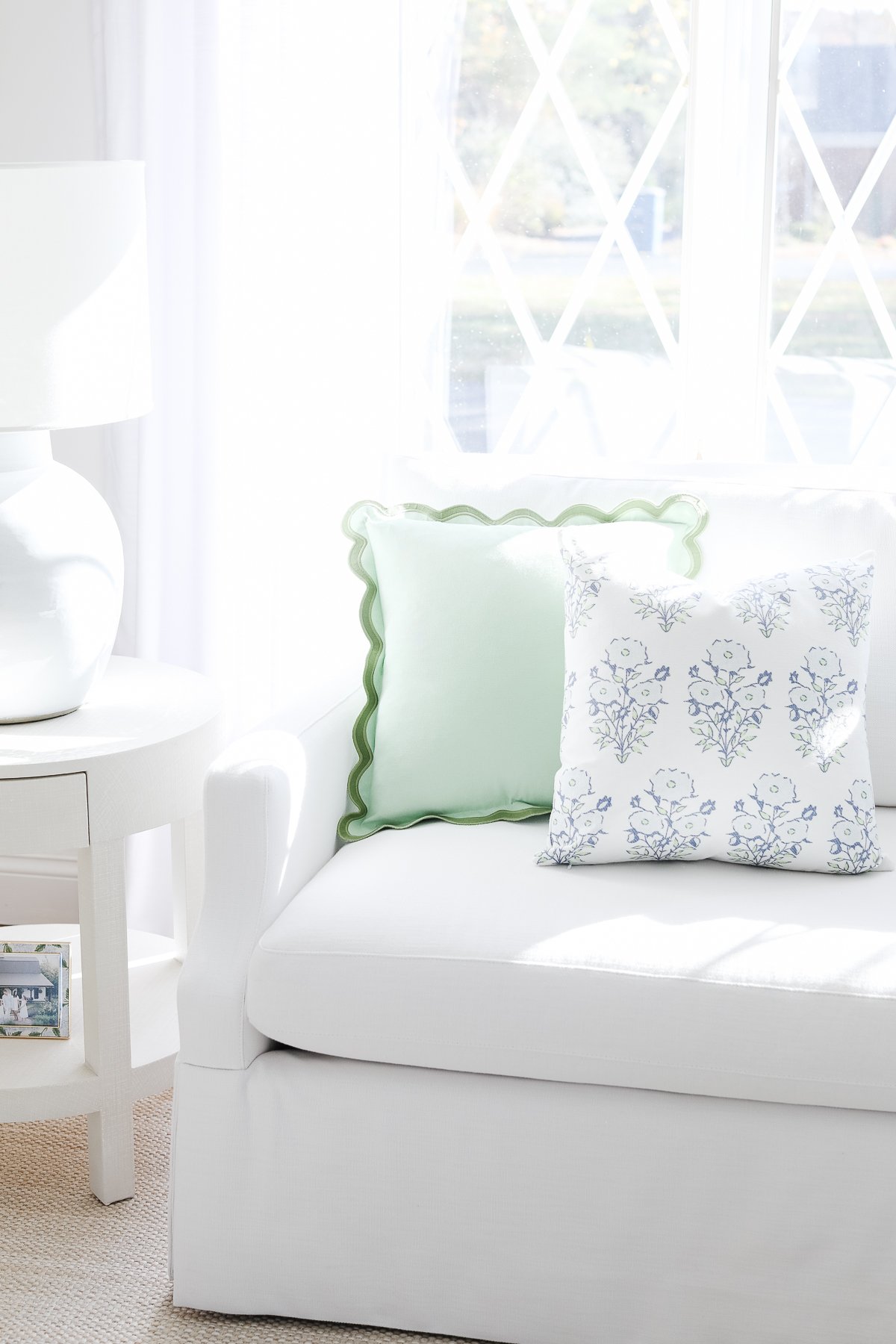 A living room with a Serena and Lily Sofa, white couch, and blue pillows.