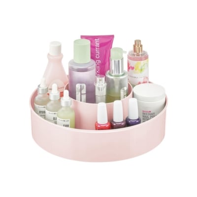 A pink tray serving as a storage container for cosmetics.