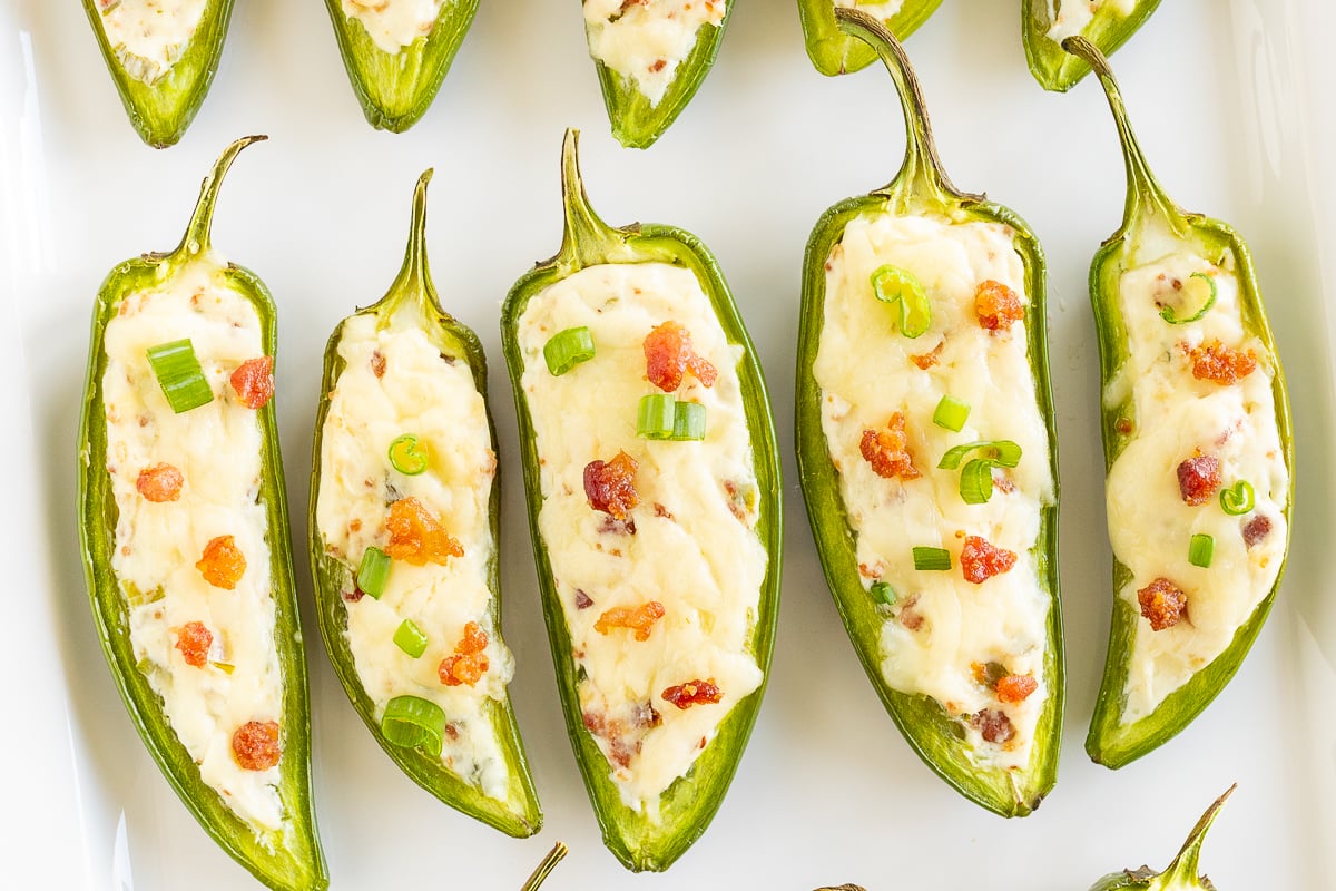Stuffed jalapenos on a white plate.