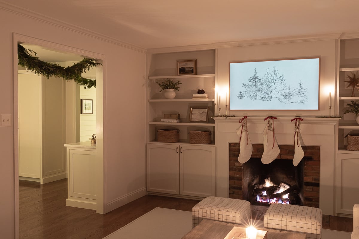 A living room with a fireplace and stockings.