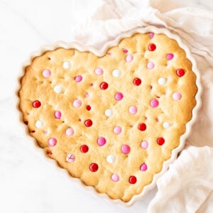 A heart shaped cake with sprinkles on top, perfect for Valentine's Day.