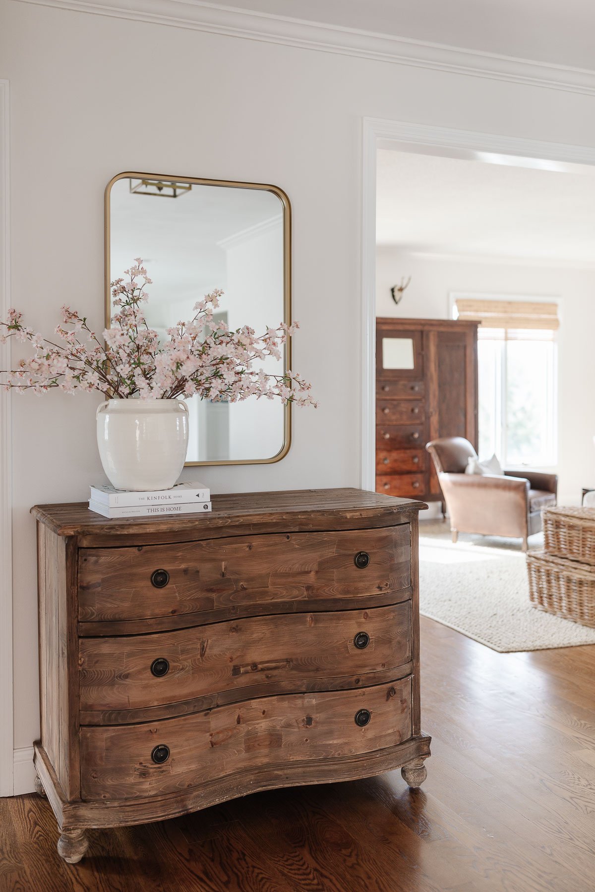 A curved wooden dresser in a living room.