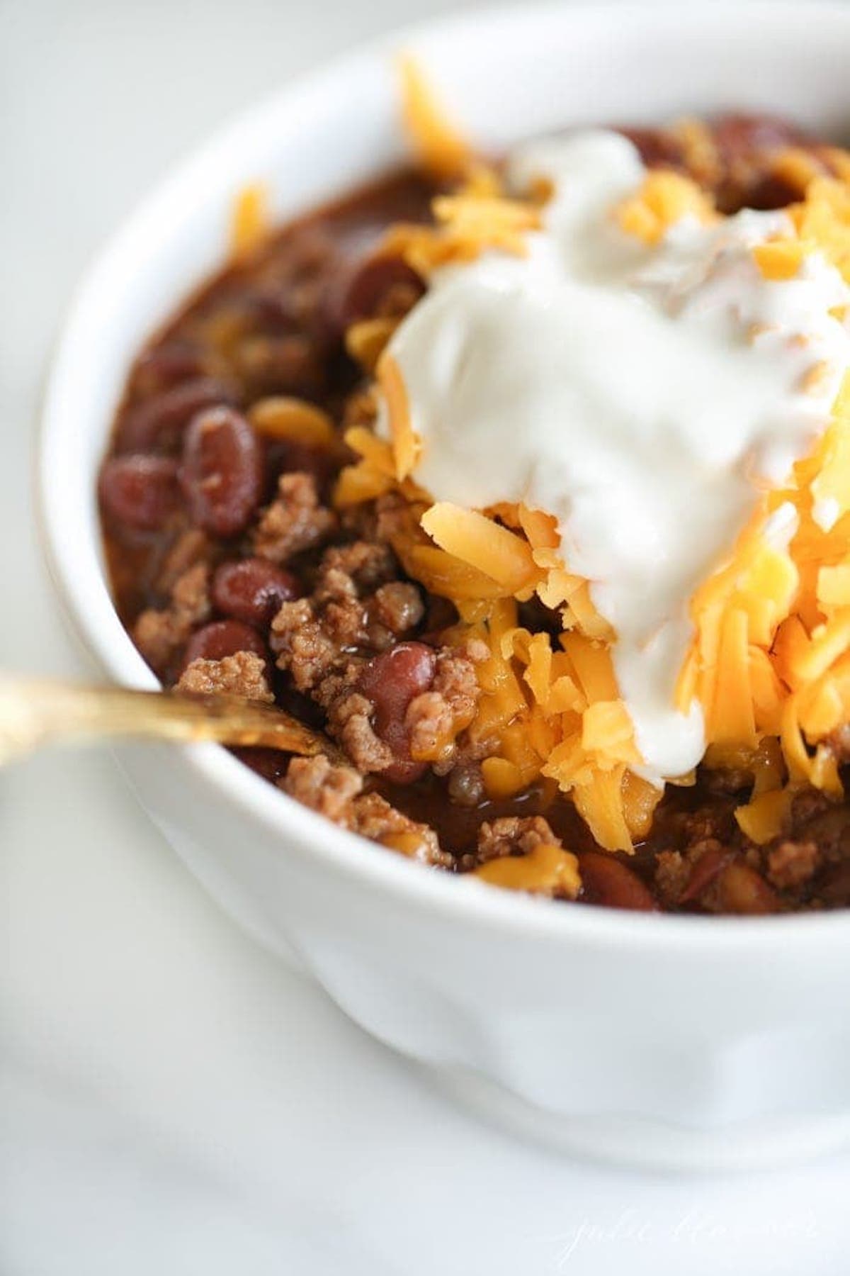 An easy bowl of chili with cheese and sour cream.