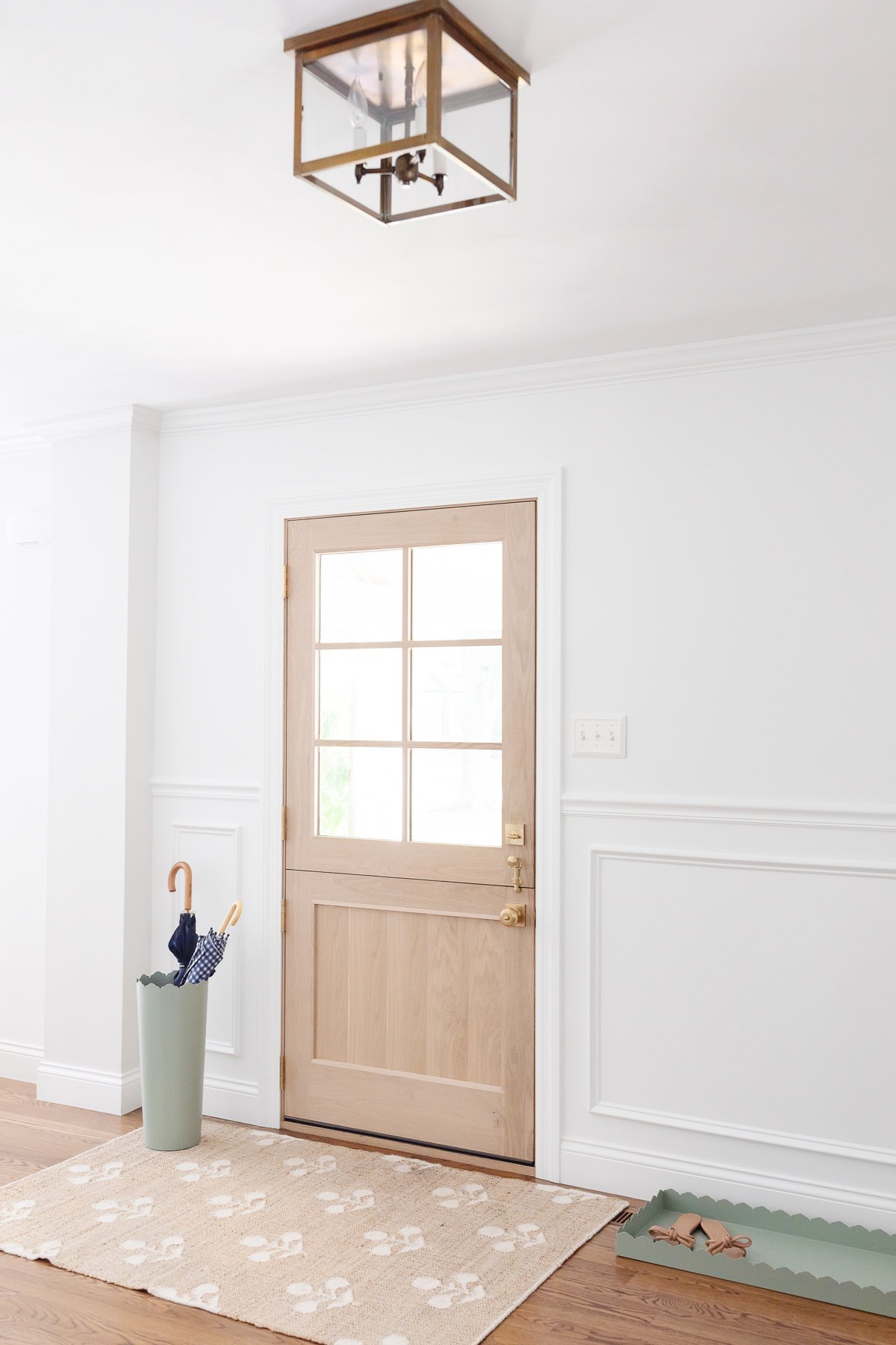 Enhance a room with a light fixture and a rug at the doorway, effectively adding light to the space.