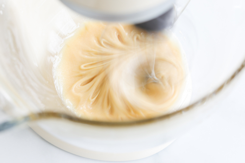 Whipped honey being processed in a stand mixer.