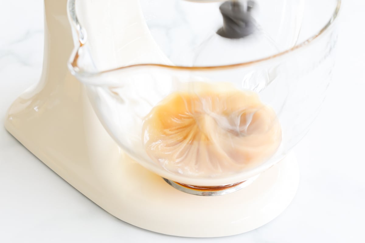 Whipped honey being processed in a stand mixer.