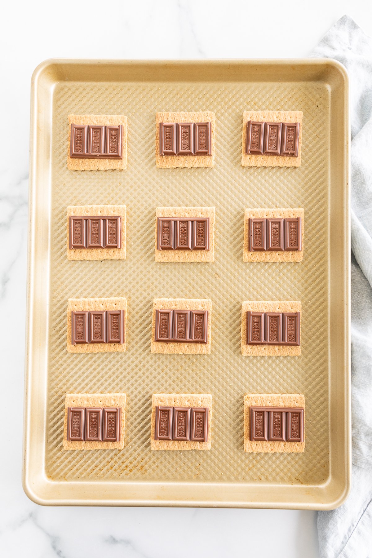 Oven-baked s'mores bars on a baking sheet.