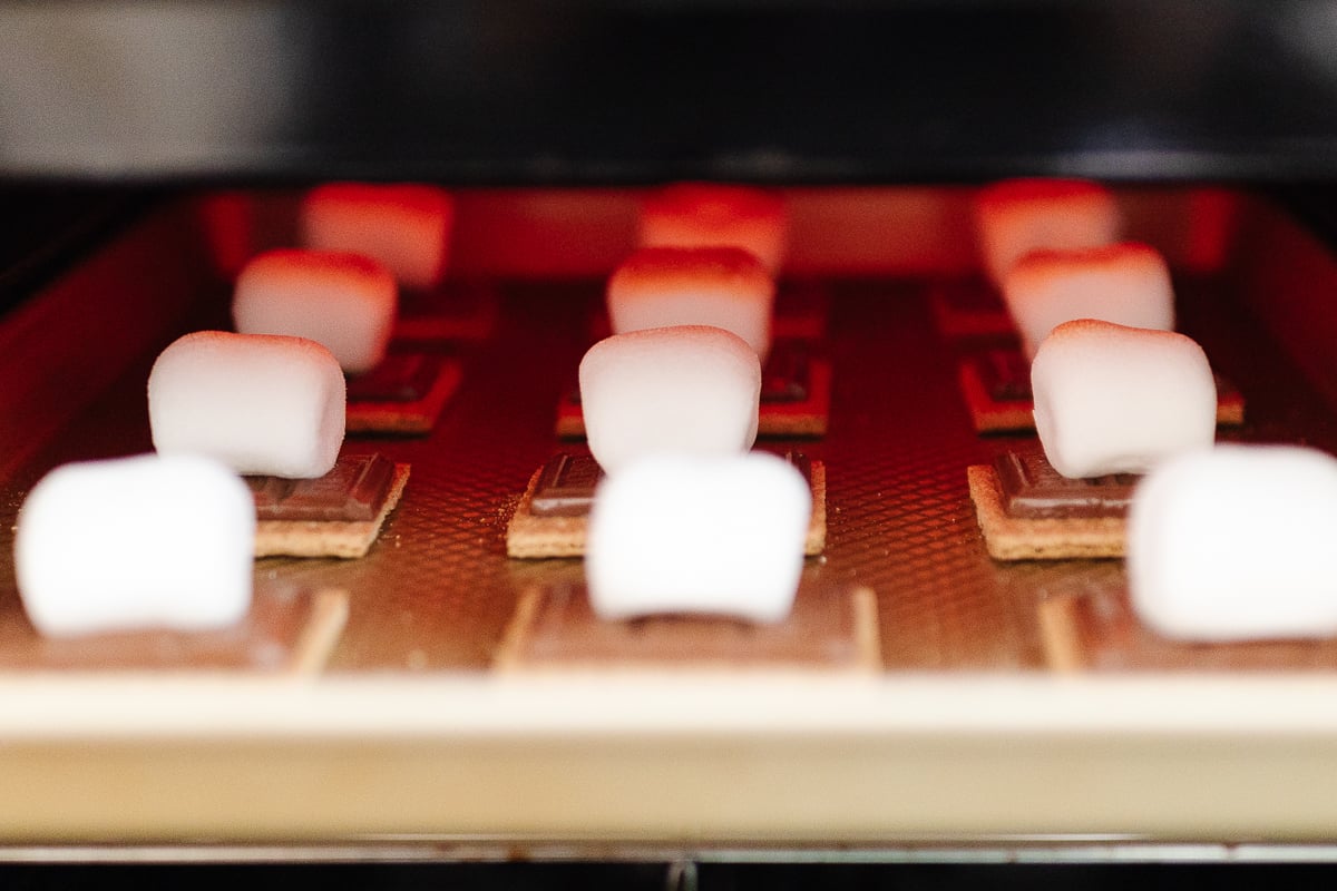 s'mores being heated in an oven.