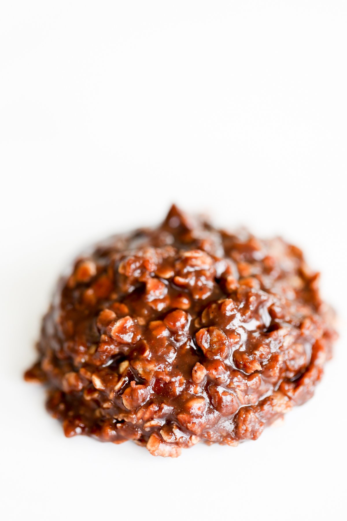 A chocolate covered cookie on a white surface, commonly known as preacher cookies.