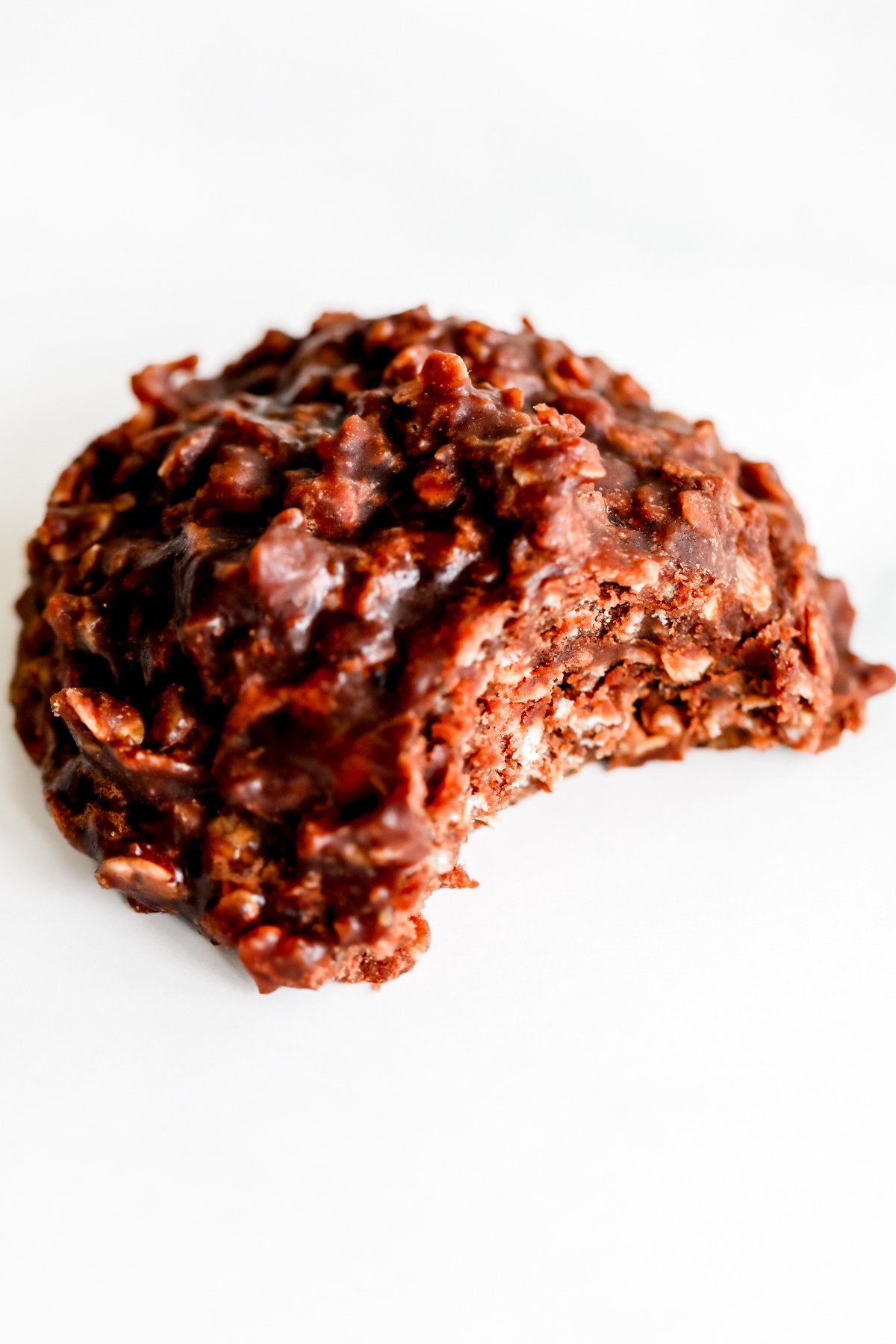 A piece of chocolate cookie on a white surface, also known as a preacher cookie.