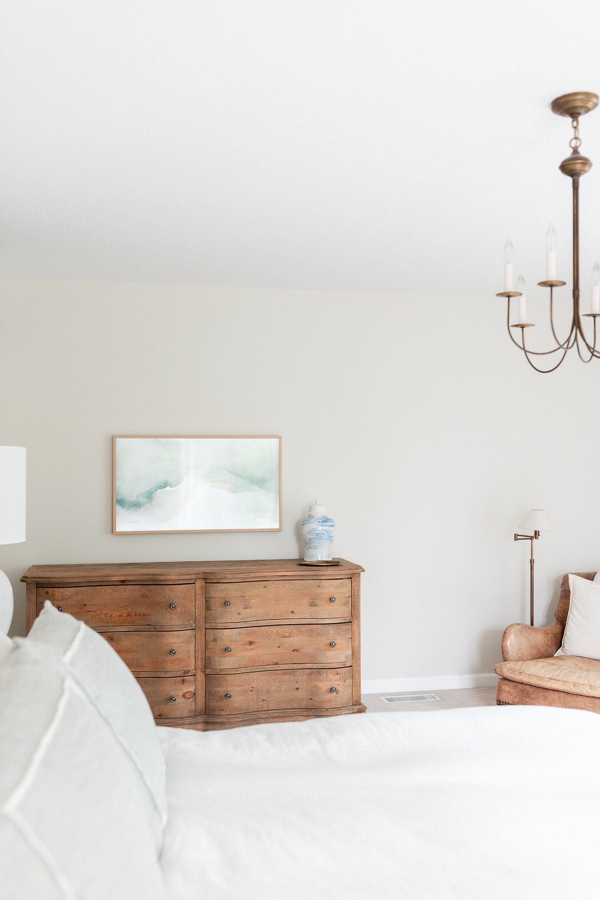 A white bed in a bedroom, inspired by the RH Look for Less design.