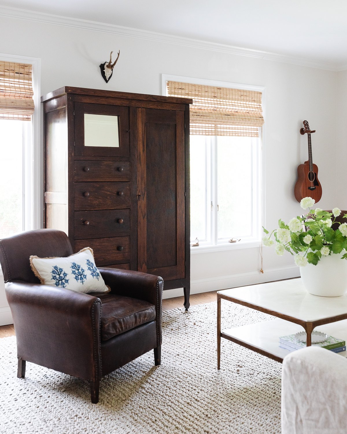 A small living room with a chair and a table, designed to make the room look bigger.