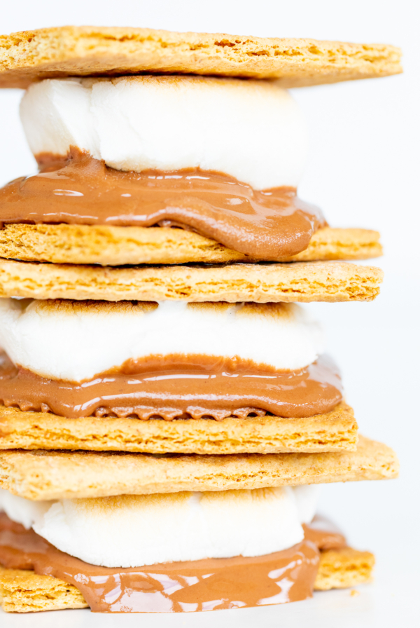 A stack of oven-baked s'mores topped with chocolate and marshmallows.