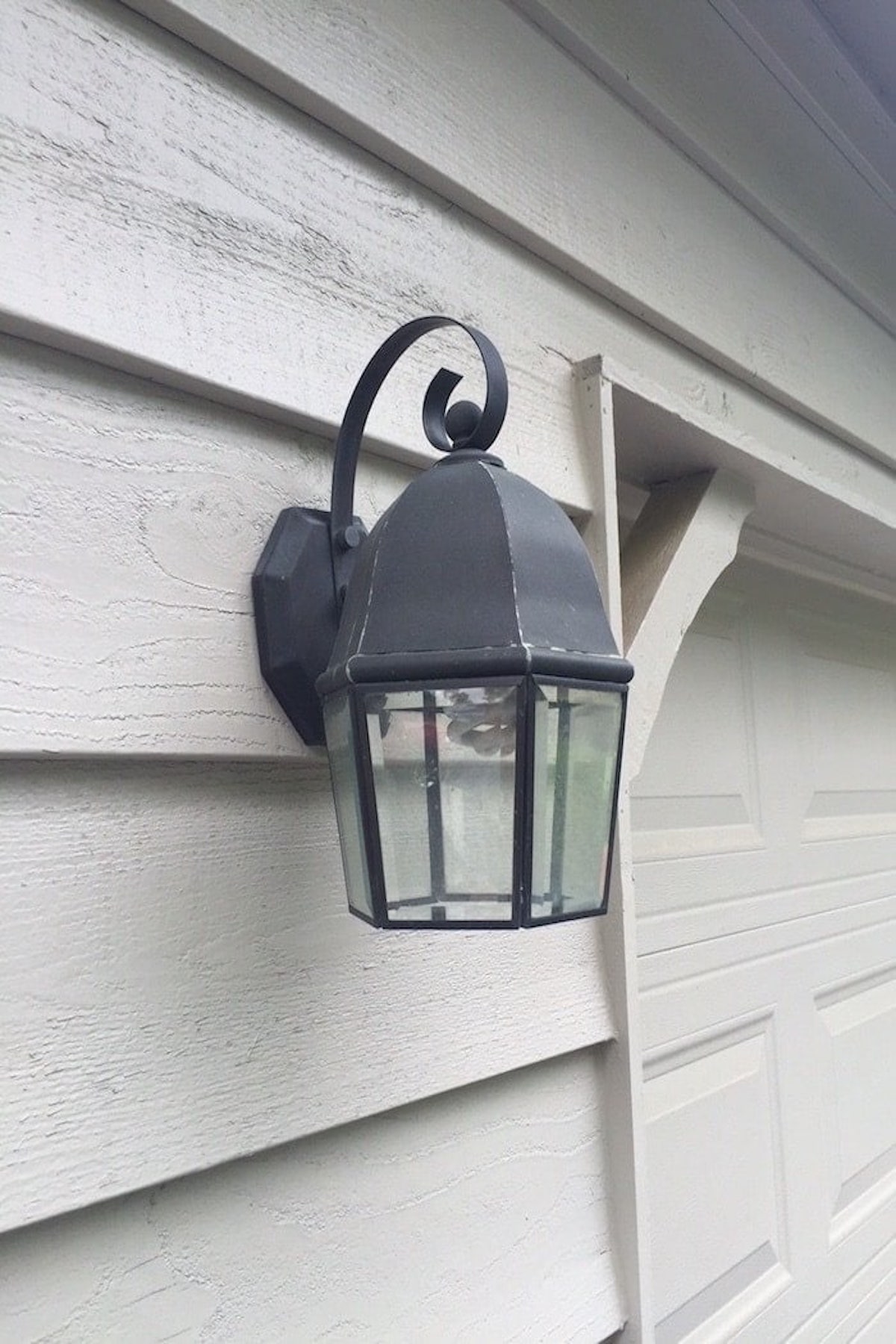 A copper lantern adorning the side of a house.