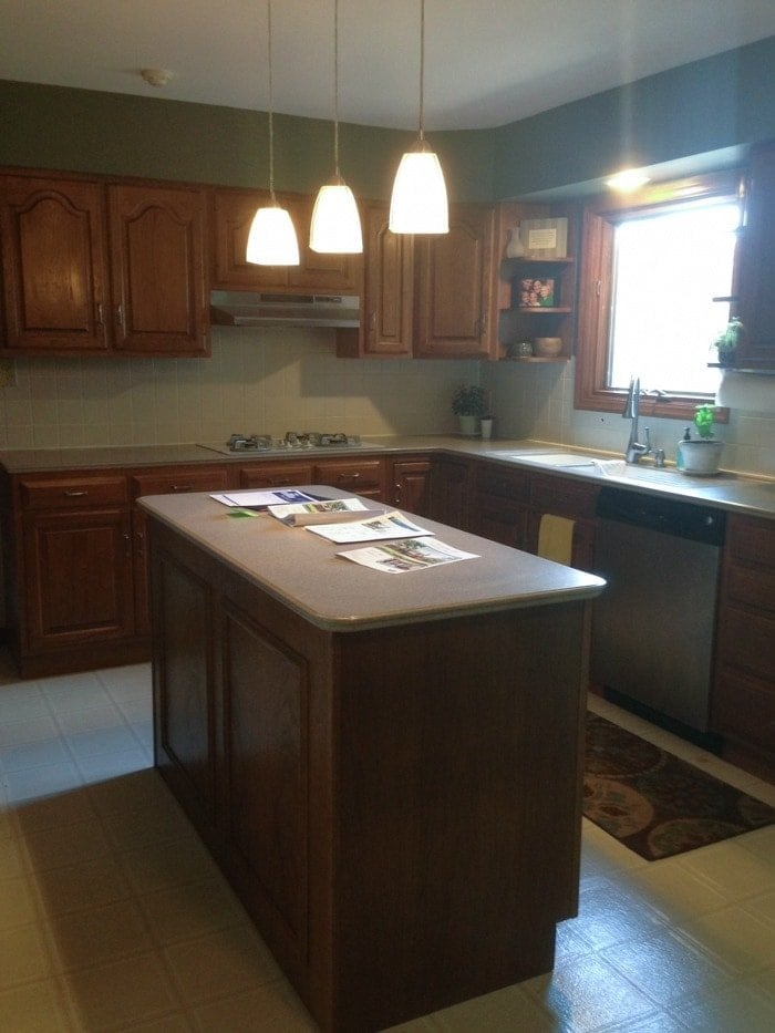 A shaker style kitchen with wooden cabinets and a center island.