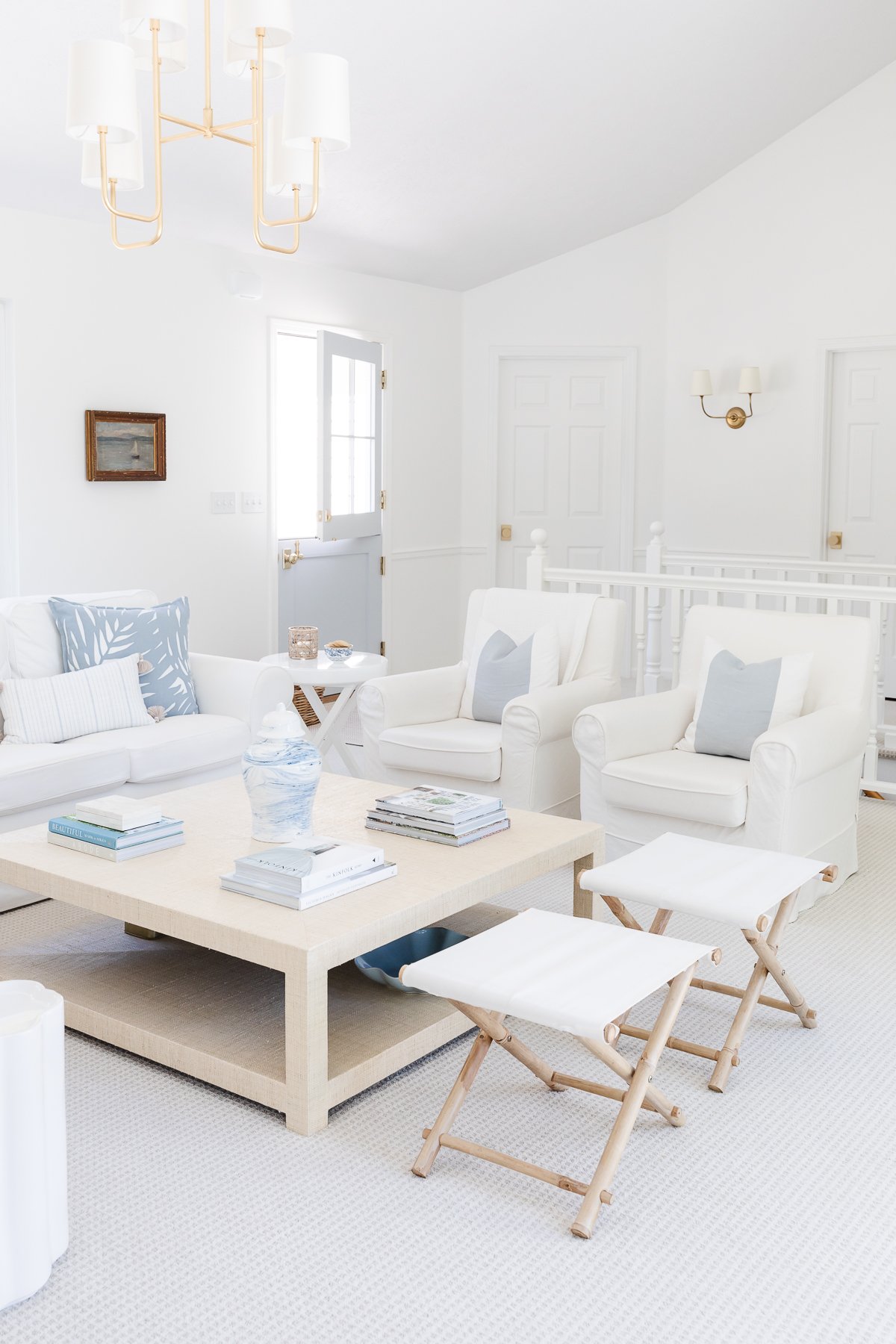 A lake house living room with white furniture.